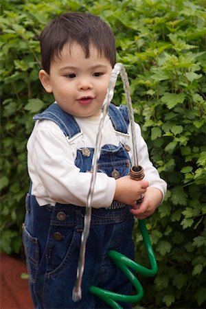 spraying water hose - Boy Using Hose Stock Photo - Rights-Managed, Code: 700-00522525