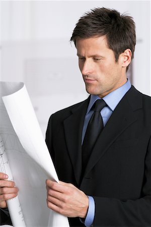 drawing of man looking at reflection - Businessman With Blueprints Stock Photo - Rights-Managed, Code: 700-00522802