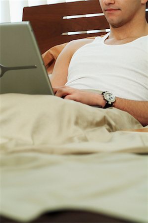 Man Using Laptop Computer In Bed Stock Photo - Rights-Managed, Code: 700-00522927