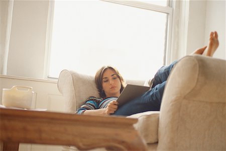 Woman Reading on Sofa Fotografie stock - Rights-Managed, Codice: 700-00523253