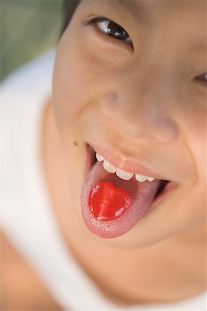 Girl with Candy on Tongue Foto de stock - Con derechos protegidos, Código: 700-00523296