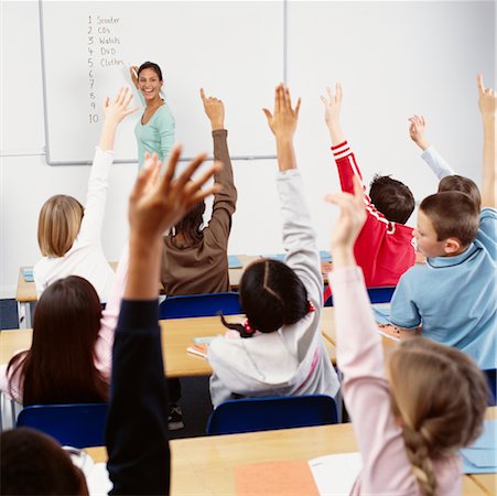 students with hands raised in classroom with female teacher - Students with Hands Raised in Classroom Stock Photo - Rights-Managed, Code: 700-00523357
