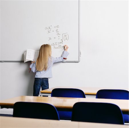 Student Writing On Whiteboard In Classroom Stock Photo - Rights-Managed, Code: 700-00523383