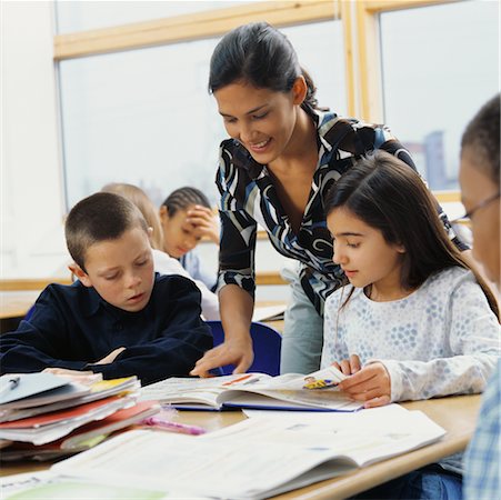 simsearch:6109-06196557,k - Teacher Helping Students in Classroom Stock Photo - Rights-Managed, Code: 700-00523413