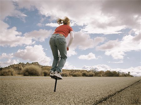 Femme sautant sur Pogo Stick Photographie de stock - Rights-Managed, Code: 700-00523458