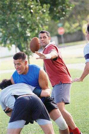 football player curly hair - Men Playing Football Stock Photo - Rights-Managed, Code: 700-00523707