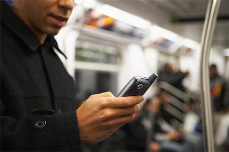 Man Using Cell Phone on Subway Stock Photo - Rights-Managed, Code: 700-00523949