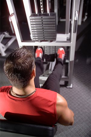 simsearch:700-00530584,k - Homme fait la jambe-presse dans la salle de Gym Photographie de stock - Rights-Managed, Code: 700-00530589