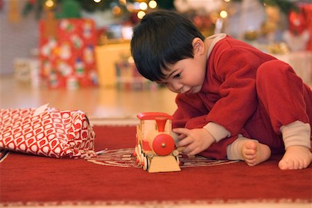 Boy Playing with Toy Train on Christmas Morning Stock Photo - Rights-Managed, Code: 700-00544361