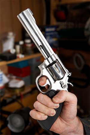 Close-up of Man's Hand Holding Handgun Stock Photo - Rights-Managed, Code: 700-00546355