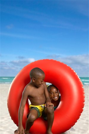 preteen black girl bathing suit - Boy and Girl with Inner Tube on Beach Stock Photo - Rights-Managed, Code: 700-00546439