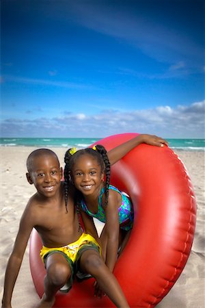 preteen black girl in bathing suit - Boy and Girl with Inner Tube on Beach Stock Photo - Rights-Managed, Code: 700-00546440