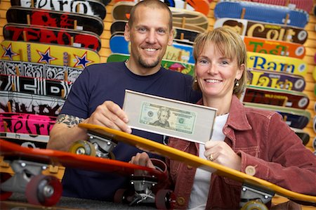 small business cash - Couple Holding Framed Dollar Bill in Skateboard Store Stock Photo - Rights-Managed, Code: 700-00546728