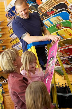 dad with tattoos - Mother and Children Looking at Skateboards in Store Stock Photo - Rights-Managed, Code: 700-00546737