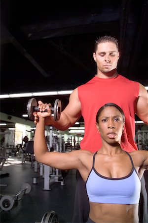 spotting at the gym - Woman Lifting Weights with Personal Trainer Stock Photo - Rights-Managed, Code: 700-00549235