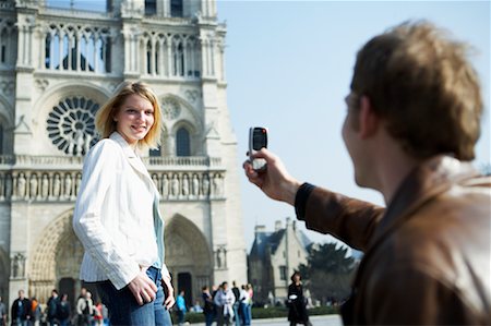 Man Photographing Woman in Front of Notre Dame Cathedral, Paris, France Stock Photo - Rights-Managed, Code: 700-00549675