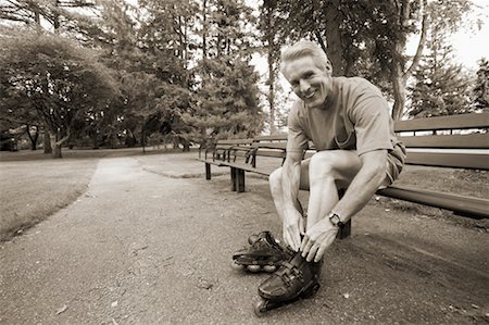 Man Putting on Roller Blades Stock Photo - Rights-Managed, Code: 700-00549915