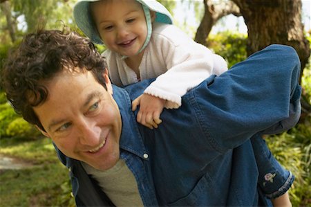 piggyback ride in the garden - Father Giving Daughter Piggyback Ride Stock Photo - Rights-Managed, Code: 700-00549958