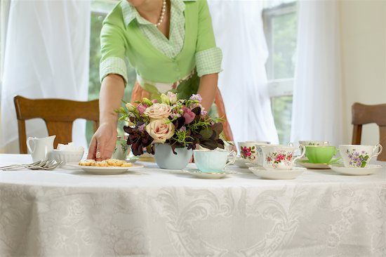 Woman Setting Table with Vintage Teacups Stock Photo - Premium Rights-Managed, Artist: Janet Bailey, Image code: 700-00543580