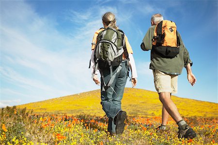 simsearch:700-00459814,k - Couple Hiking Through Wildflowers Fotografie stock - Rights-Managed, Codice: 700-00554618