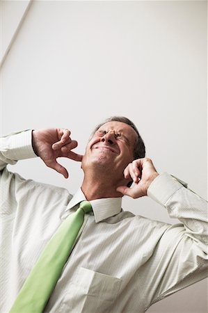 plugging ears - Homme d'affaires brancher les oreilles Photographie de stock - Rights-Managed, Code: 700-00554687