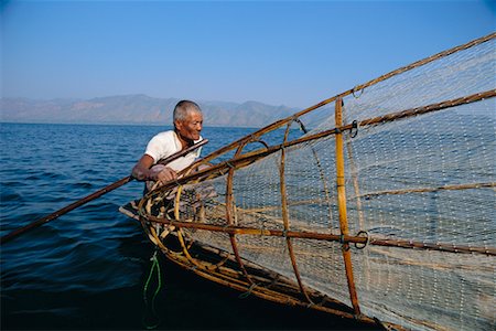 Man Fishing on Boat, Inle Lake, Myanmar Stock Photo - Rights-Managed, Code: 700-00554856