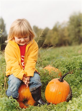 photos of little girl praying - Child Sitting on Pumpkin in Field Stock Photo - Rights-Managed, Code: 700-00554978