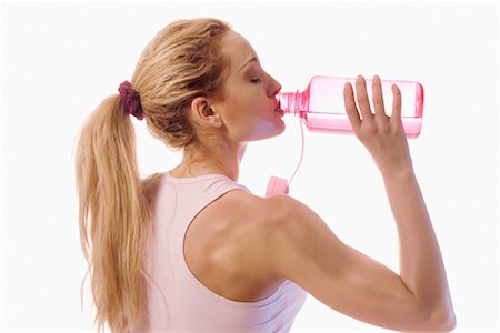 satisfied (thirst) - Woman Drinking from Water Bottle Foto de stock - Con derechos protegidos, Código: 700-00556140