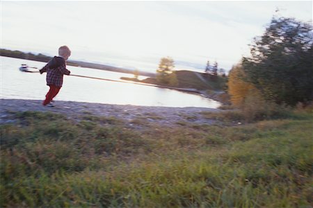 side view of girl toddler walking - Child On Riverbank, Calgary, Alberta Stock Photo - Rights-Managed, Code: 700-00556213