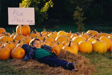 Boy Lying Down at Pumpkin Patch Stock Photo - Rights-Managed, Code: 700-00556840