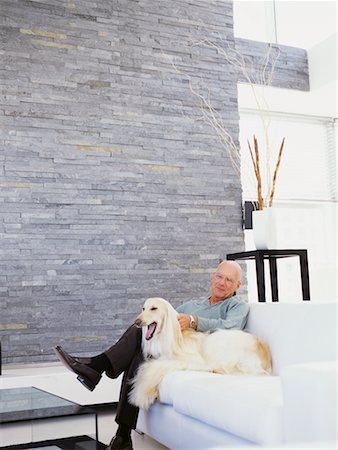 Man and Dog Sitting on Sofa Stock Photo - Rights-Managed, Code: 700-00557015