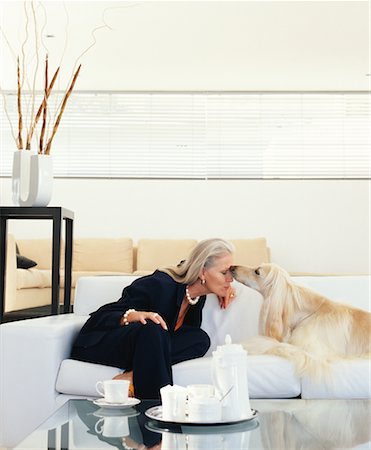 pic of dog licking woman - Woman Sitting on Sofa With Dog Stock Photo - Rights-Managed, Code: 700-00557025