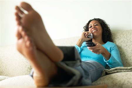 feet sofa comfort - Woman Using Cellular Telephone Stock Photo - Rights-Managed, Code: 700-00550009