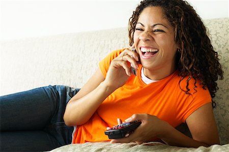 Woman Using Cellular Telephone and Watching Television Stock Photo - Rights-Managed, Code: 700-00550015