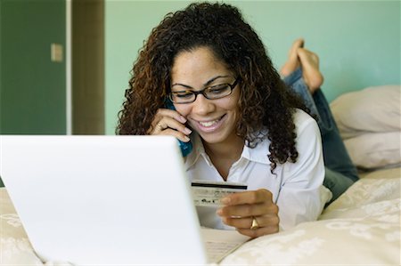 Woman Using Credit Card, Laptop Computer and Cordless Phone Stock Photo - Rights-Managed, Code: 700-00550030