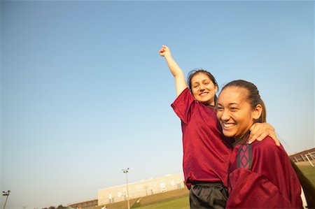 football team celebration - Son coéquipier Holding up Girl Photographie de stock - Rights-Managed, Code: 700-00550135