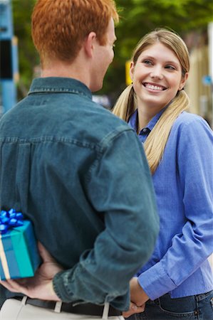 Young Man Surprising Young Woman With A Gift Stock Photo - Rights-Managed, Code: 700-00550191