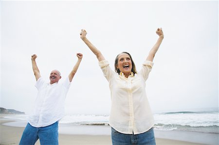 senior women stretching on beach - Couple Cheering on Beach Stock Photo - Rights-Managed, Code: 700-00550354