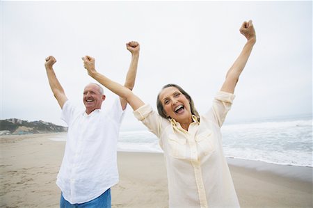 senior women stretching on beach - Couple Cheering on Beach Stock Photo - Rights-Managed, Code: 700-00550355