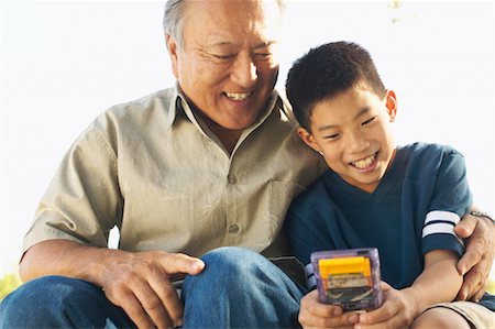 simsearch:6113-07762196,k - Grandfather Watching Grandson Play Video Game Stock Photo - Rights-Managed, Code: 700-00550617