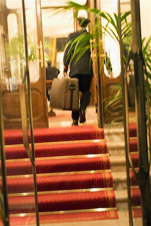 suitcase for italy - Bellhop Carrying Luggage Stock Photo - Rights-Managed, Code: 700-00550648