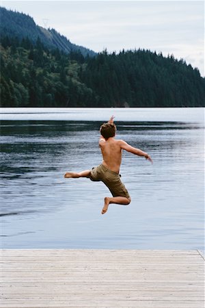 Boy Jumping into Lake, Buntzen Lake, British Columbia, Canada Stock Photo - Rights-Managed, Code: 700-00551579