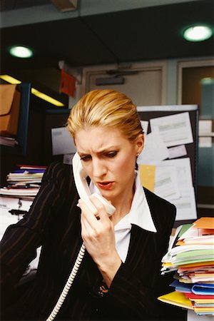 stressful women at the office with piles of work - Businesswoman Using Phone Stock Photo - Rights-Managed, Code: 700-00552189