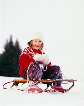 Girl Sitting on Sled Stock Photo - Rights-Managed, Code: 700-00552255