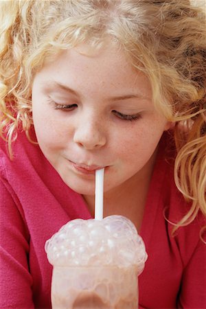 Girl Blowing Bubbles into Milk Stock Photo - Rights-Managed, Code: 700-00552301