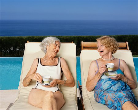swim accessories - Women Drinking Tea By Swimming Pool By the Ocean Stock Photo - Rights-Managed, Code: 700-00552914