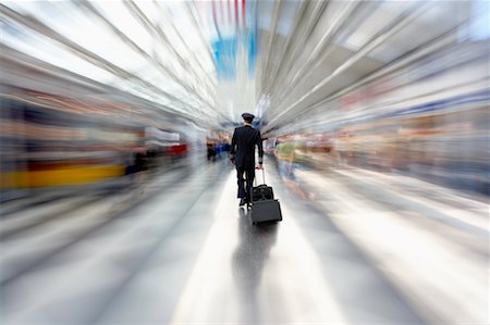 Pilot Walking Through Airport Stock Photo - Rights-Managed, Code: 700-00553048