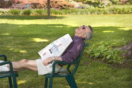 relaxing in the garden with a newspaper - Man Sleeping in Backyard Stock Photo - Rights-Managed, Code: 700-00560484