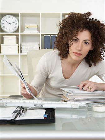 stressful women at the office with piles of work - Woman at Desk with Bills Stock Photo - Rights-Managed, Code: 700-00560859