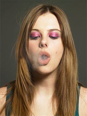 smoke ring - Woman Exhaling Smoke Stock Photo - Rights-Managed, Code: 700-00561878
